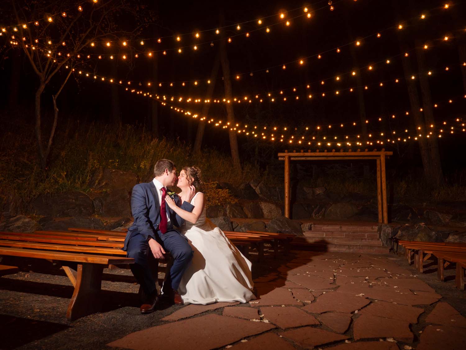 couple under sparkly lights at the pines wedgewood weddings
