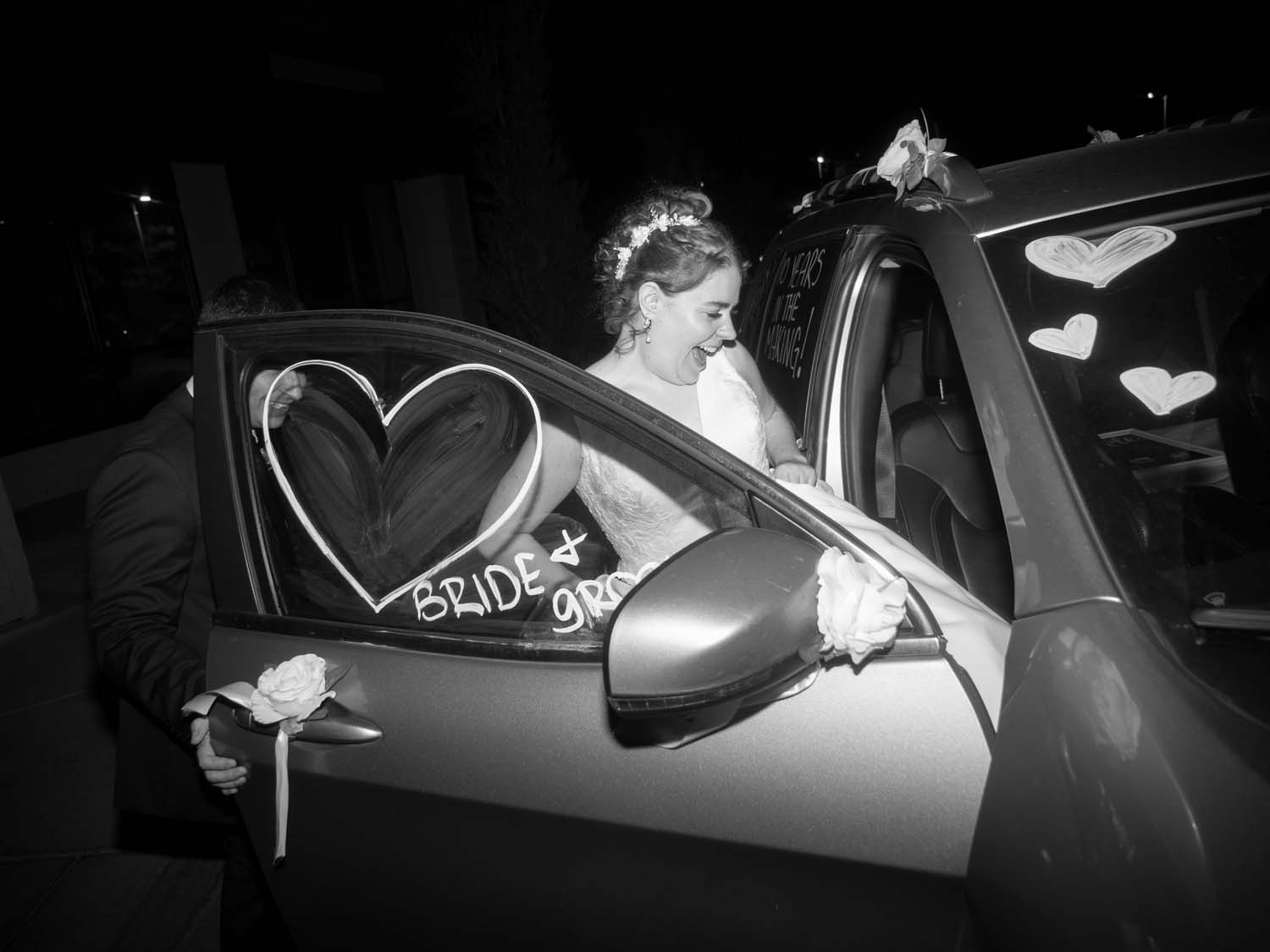 bride gets into car after wedding
